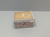 a small wooden box with writing on it sitting on a table