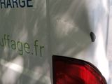 a white van that is parked on the side of the road