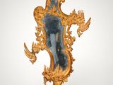 an image of a gold mirror with a bird on it