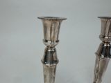 pair of silver plated candlesticks in the shape of candlesticks