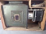 an old camera sitting inside of a wooden box