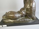 a bronze statue of a bear and a dog on a marble base