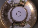 a gold plate with a picture of a castle on it