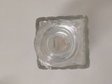a small glass block with a hole in it