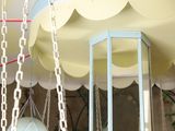 a bird cage hanging from the ceiling of a room