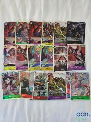a bunch of cards are laying on a bed with a white sheet