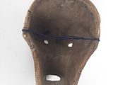 a close up of a wooden mask on a white background