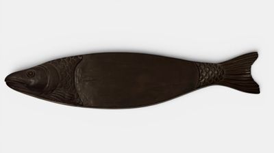 a brown fish shaped object on a white surface