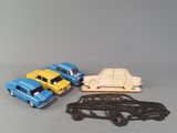 three toy cars are lined up next to each other on a table