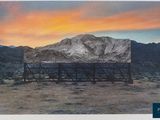 an old photo of a billboard in the desert with mountains in the background