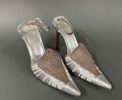 a close up of a pair of silver shoes on a table