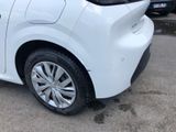 a small white car parked in a parking lot