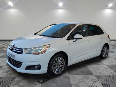 the white citrole is parked on a checkered tile floor