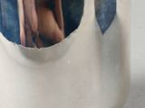 a silver cup with a handle that has a picture of a woman on it