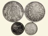 a close up of three different coins on a white background