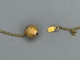 a close up of a chain with a ball on it