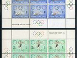 four stamps with olympic symbols on them are displayed in a black frame