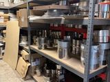 many pots and pans on the shelves in the kitchen
