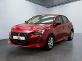 a red car parked in a large room with a white wall