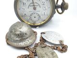 a silver pocket watch with a chain around it