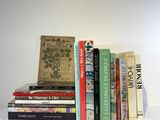 many books stacked on top of each other on a table