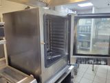 a commercial oven in a commercial kitchen with the door open