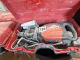 a red box with tools inside of it on the floor