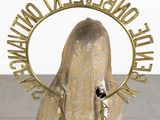 a statue of a woman with a veil on it ' s head in front of a mirror