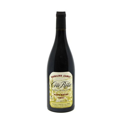 a bottle of red wine sitting on top of a white table