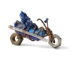 a figurine of a man riding a motorcycle with a basket on the back of it