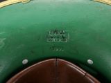 a close up of a green hat with a yellow band