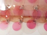 a pink and white polka dot design on the fabric