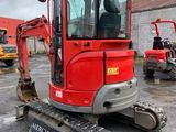 an image of a red excavator parked in a parking lot