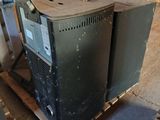 an old tv sitting on top of a pallet in a warehouse