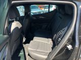 the back seat of a car with the door open in a parking lot