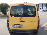 a yellow van that is parked in a parking lot
