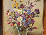 a painting of flowers in a glass vase on a easel