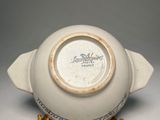 a white bowl with a blue and white design on it