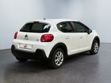 the rear end of a white citrole parked in a room