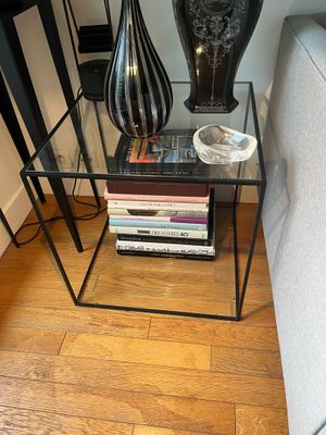 two vases sitting on top of a table next to a couch