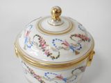 a white and gold box with flowers and birds on it