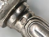 a close up of a silver knife on a table