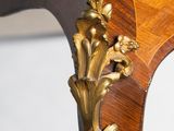 an antique wooden table with a marble top and gold leaf decoration