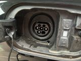 a close up of a car ' s fuel tank with a car plugged into it