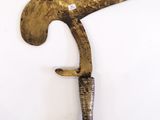 a very old knife that is hanging on the wall