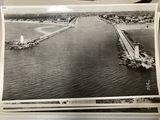 an old black and white photo of a bridge over a body of water