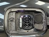 a picture of an electric car charging at the charging station