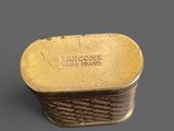 an image of a close up of a gold plate on a gray surface