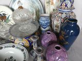 many different vases and bowls sitting on a table