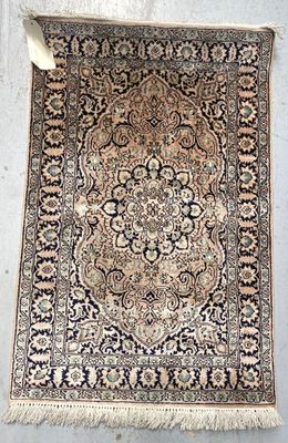 an antique persian rug with a medallion design and fringe fringes